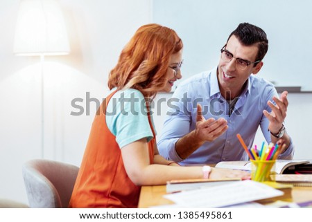 Our work. Positive joyful people feeling excited while discussing their new project Royalty-Free Stock Photo #1385495861