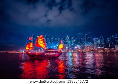 Victoria Harbor Hong Kong night view with junk ship