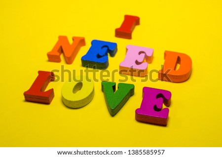 i need love written with wooden colored letters