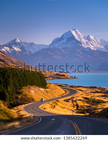 Mount Cook standing high above the blue waters of Lake Pukaki in New Zealand's South Island. Royalty-Free Stock Photo #1385622269