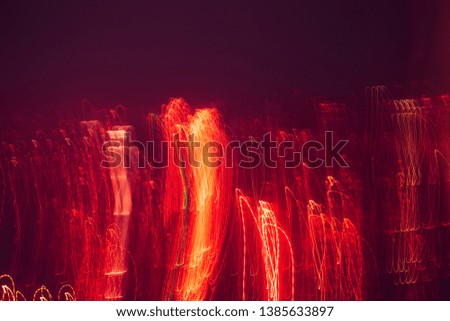Abstract background with lights and movement, lines and lights in blur. red flashes on black background