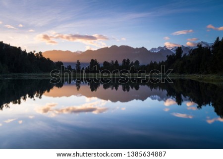 Mount Tasman and Mount Cook reflect in the early morning light on Lake Matheson.