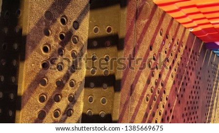 Shades of brown and red abstract background with round patterned holes and diagonal line striped shadows. Dusty metal surface with sandy dust. Geometry backdrop. Rough textures.