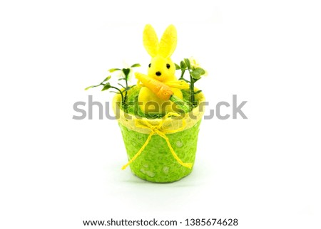 Toy yellow bunny with carrot isolated in white background, easter bunny concept