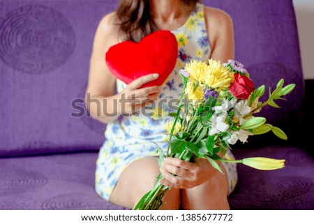 Bouquet of flowers and a red heart in the hands of a woman - Image