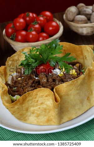 Beef and cheese in tortilla bowl - Mexican Food