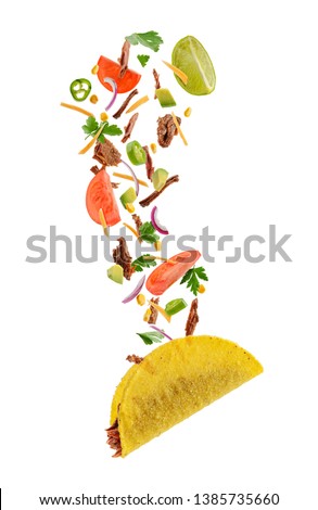 Flying taco ingredients on white background. Tomato, lime, cilantro, jalape?o, cheese, onion and beef.