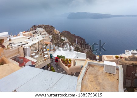 View of byzantine castle ruins with caldera background in a rainy day