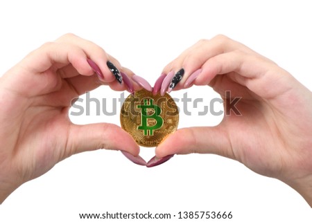 Hands holds and shows the heart new golden cryptocurrency bitcoin in hands on white background. Concept of bitcoin grows in price
