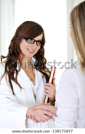 A female doctor standing in modern hospital office
