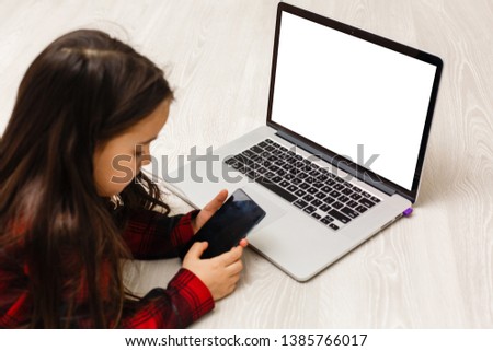 Little girl Hands holding credit card and using laptop.Online shopping in childhood.