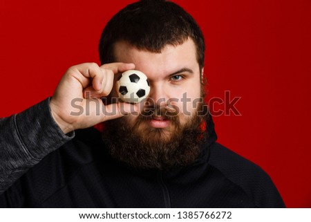 Happy young man holding a soccer ball