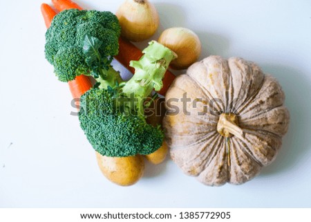 Group of green brocoli yellow pumpkin and orange carrot vegetable on white background