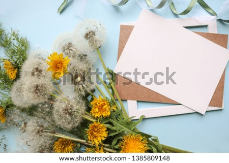 spring composition. bouquet of dandelions and an envelope