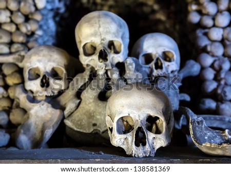 Human skulls in the basement crypt. Soft focus