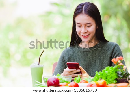 Asian beautiful young girl hold smartphone take picture eating salad vegetable outdoor , Concept healthy body