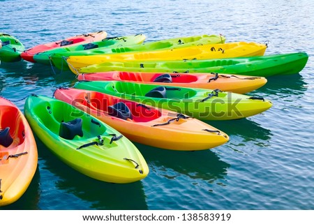 Group of colorful kayaks on water Royalty-Free Stock Photo #138583919