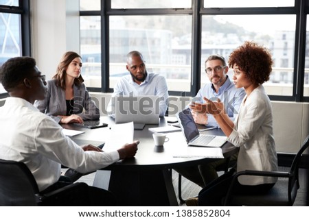 black businesswoman addressing colleagues at a corporate business meeting, close up Royalty-Free Stock Photo #1385852804