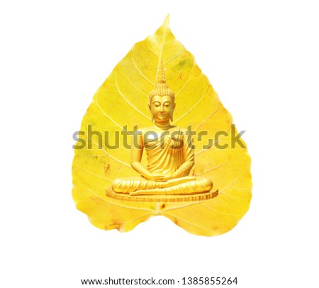 Buddha statue, meditation and a bright yellow Bodhi leaf as background Visakha Bucha Day Concept.