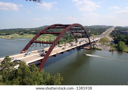 A shot of the Austin 360 Bridge on a clear calm day.  This is a very pretty picture of the bridge and a great symbol of Austin, Texas.