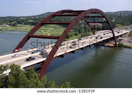 A shot of the Austin 360 Bridge on a clear calm day.  This is a very pretty picture of the bridge and a great symbol of Austin, Texas.