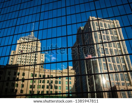 A reflection showing old and new buildings in the city of Boston.
