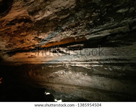 Large Cave in Mammoth Cave Kentucky with sparse lighting and formations
