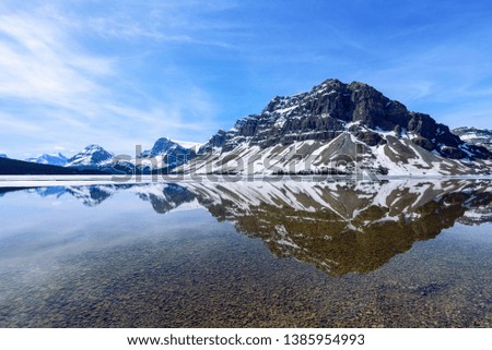 Canadian Rockies reflectIon in Bow Lake in the morning with blue sky, Springtime travel, Bow Lake, Alberta Canada