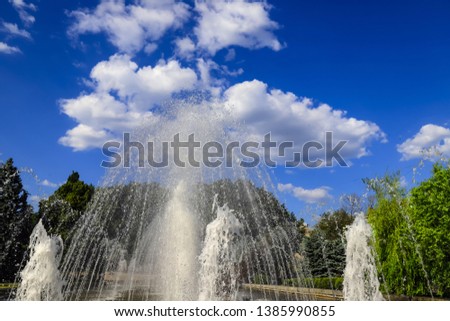 Beautiful musical, dancing fountain against the backdrop of beautiful clouds,  spring, summer cityscape, Dnepropetrovsk, Dnepr city, Ukraine