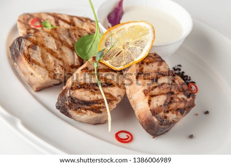 Grilled fish fillet: dorada, cod, halibut, pollock, tilapia. Seafood. Banquet festive dishes. Fine dining restaurant menu. White background.
