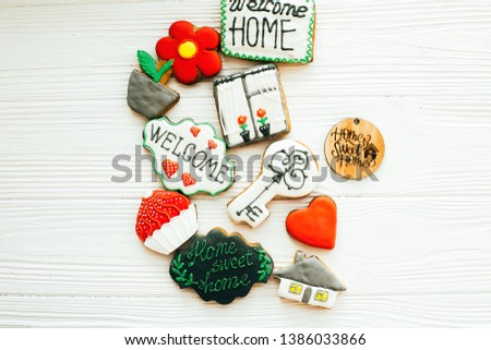 Welcome home set. Delicious key, house, plant,window,heart and welcome sign cookies on white wood, flat lay with space for text. Dream home concept. Home Sweet Home. Moving in new house