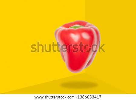 Red bell pepper levitate in air on yellow background. Concept of vegetable levitation.