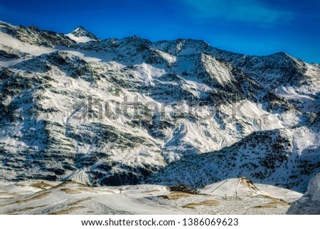 Panoramically view over Dolomites mountains with ski slopes during winter time in popular ski resort Bormio, Italy.