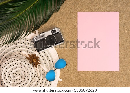 Beach theme on sand background, top view, space for text