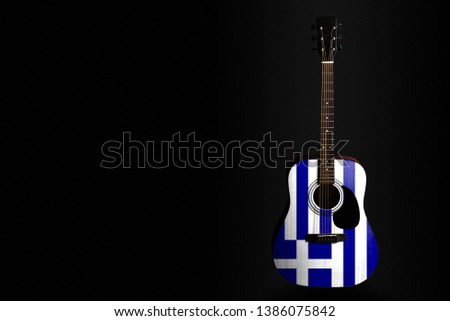 Acoustic concert guitar with a drawn flag Greece, on a dark background, as a symbol of national creativity or folk song. Horizontal frame