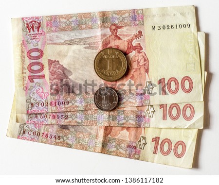 Ukrainian money. Cash. Coins one hryvnia of different years. Banknotes on a hundred hryvnia.