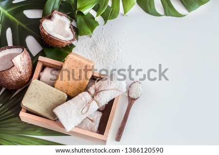 Spa composition with tropical leaves on a white background .Different organic soap, care and beauty concept, top view
