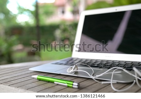 Laptop, garden background. Outdoor or home office