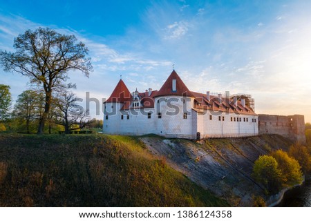 Bauska town aerial panorama with Bauska medieval castle in sunset.