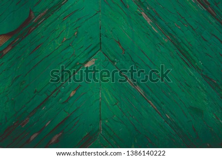 Background of green flaky wood. Backdrop of green colored wooden panels with aged flaky surface