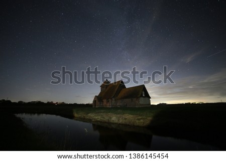 Stars and Milky Way over Fairfield Church, Romney Marsh, Kent, England on an a clear night with a little cloud
