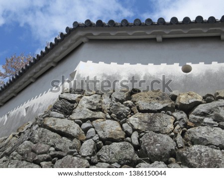 a white wall of a Japanese castle