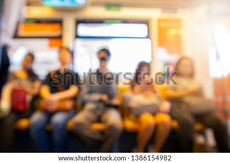 Blurry image of passenger in BTS sky train, Bangkok, Thailand.