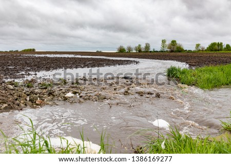 Heavy rains in the Midwest have created flooding and delayed farmers from planting corn and soybeans Royalty-Free Stock Photo #1386169277