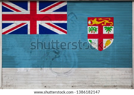 Close-up of old metal wall with national flag of Fiji. Concept of Fiji export-import, storage of goods and national delivery of goods. Flag in grunge style