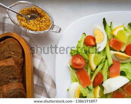 Vegetable Salad with Breadon a white plate, with bread on a deep board. healthy food, green breakfast.