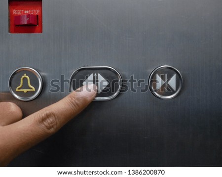 closeup of man pressing on buttons control in elevator.