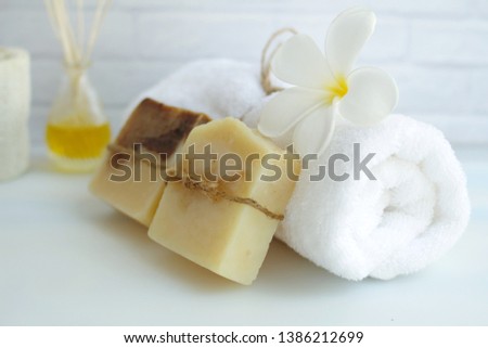 Soap and towels on the white table