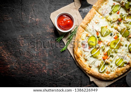 Vegetable pizza with tomato sauce in bowl. On dark rustic background