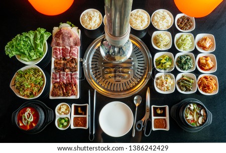 Set of beef ready for grill on stove serve with vegetable,soup and rice and slide dish, Korean style barbecue.  Royalty-Free Stock Photo #1386242429